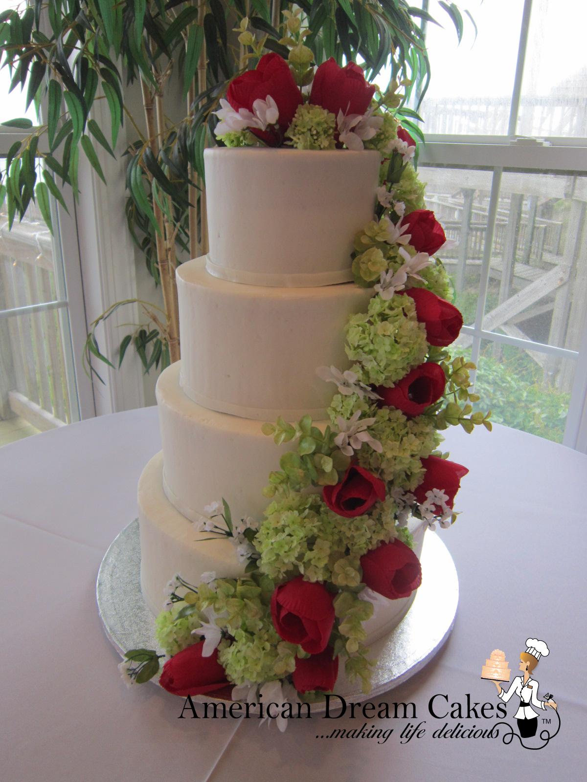 Boho white wedding cake with cascading flowers