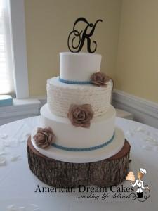 Rustic white wedding cake with ruffles and burlap