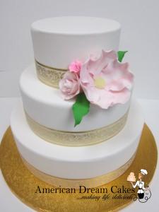 Simple wedding cake in white and gold.