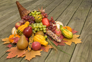 Cornucopia filled with fall harvest spilling out of it's horn of plenty