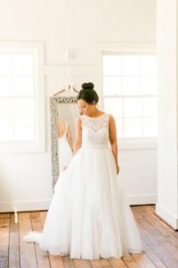 bride posing in Calista gown by Theia Couture